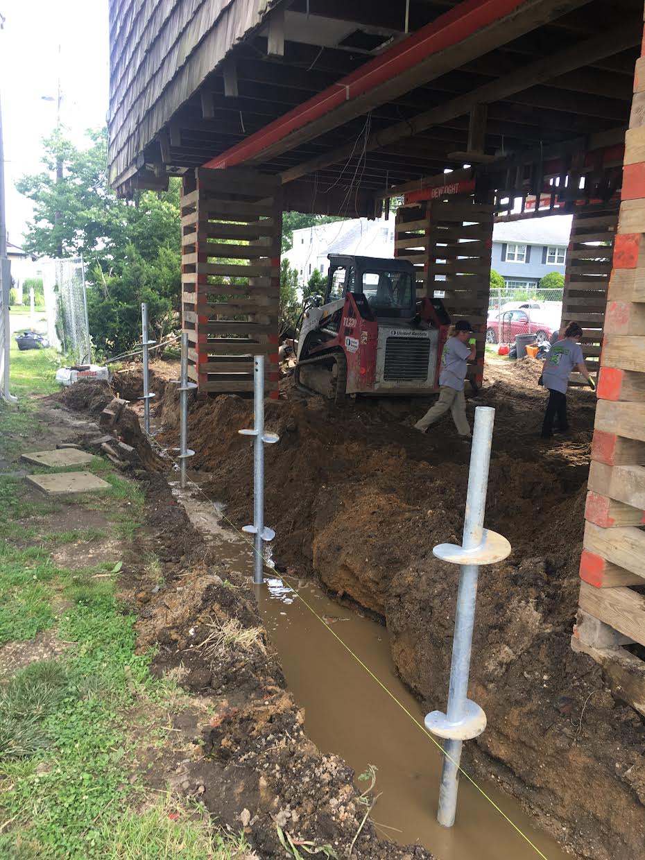some pillars on gutter and excavator